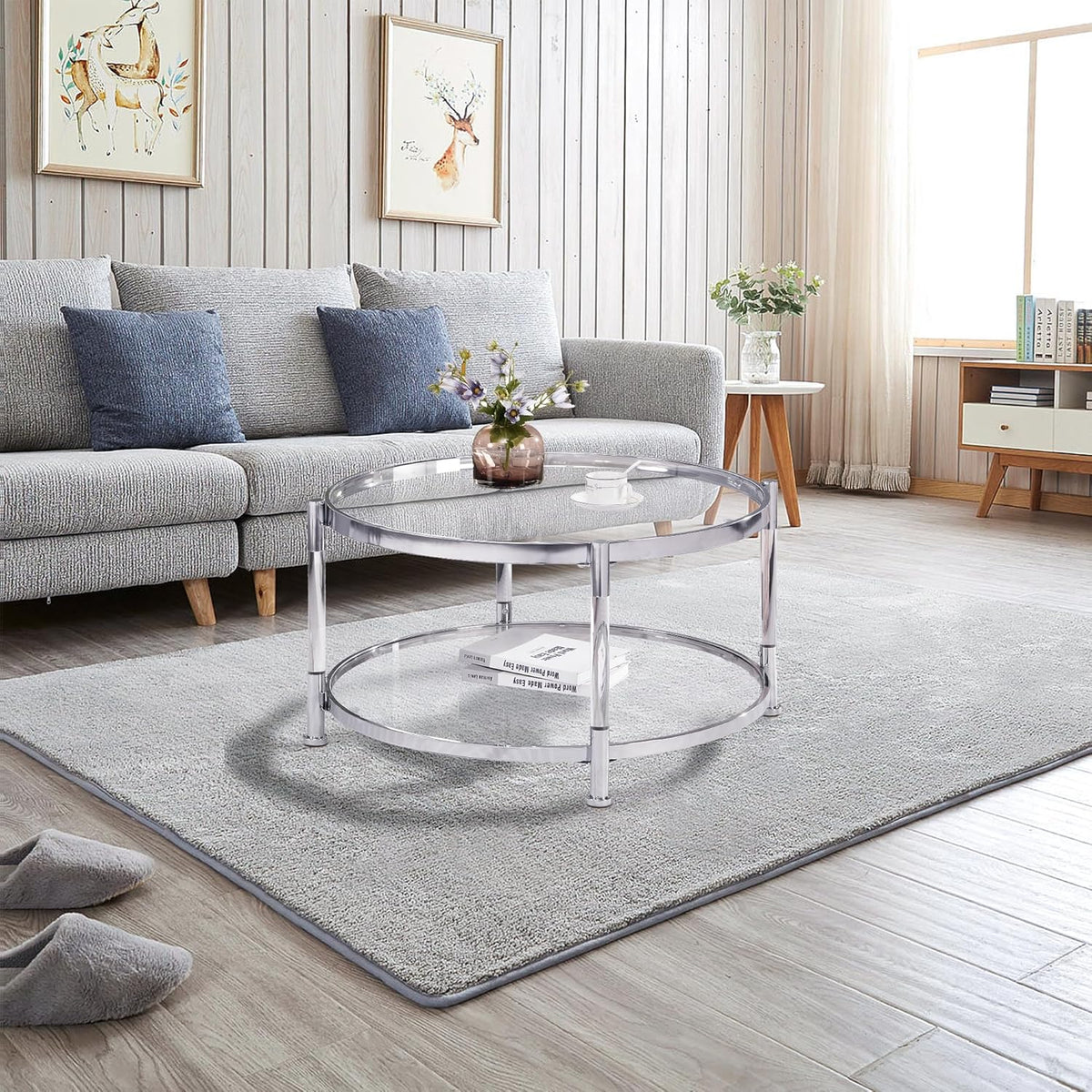 A round coffee table with a metal frame, the surface is made of chrome-plated acrylic glass.